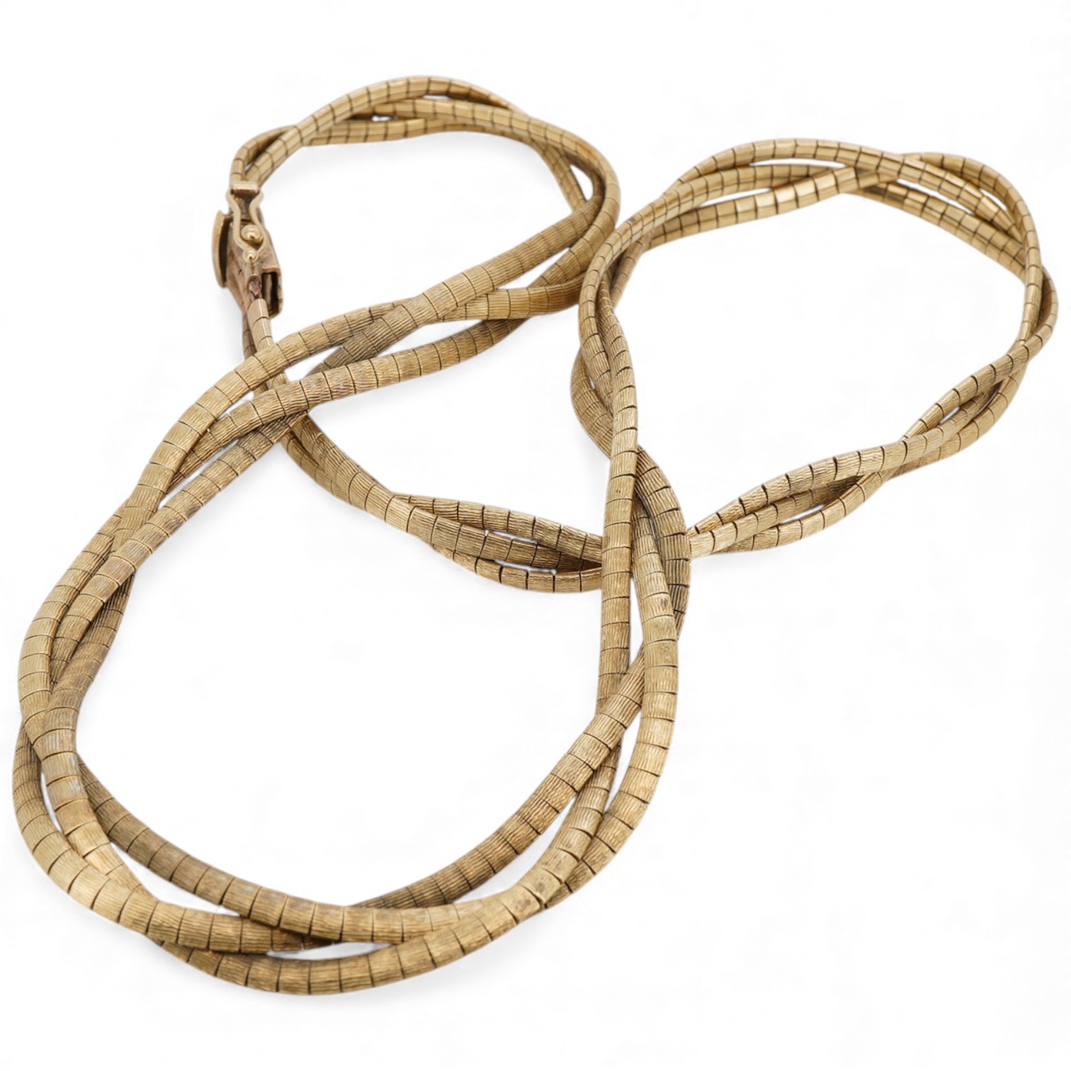 A 1970's textured 9ct gold interwoven triple strand necklace, approx. 38cm, 36 grams.